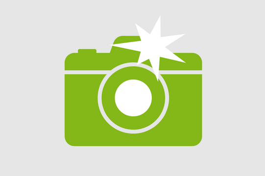 Icon: Fotokamera, die gerade auslöst